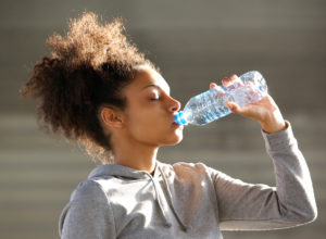 a young woman drinking water